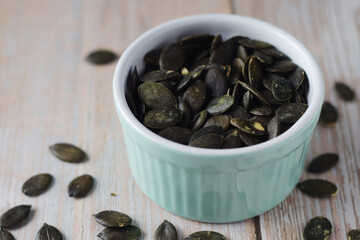 Peeled pumpkin seeds in a small bowl