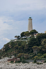 Fototapeta na wymiar View of the lighthouse on the peninsula of Saint Jean Cap Ferrat in cloudy weather, on the French Riviera