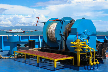 Mooring winch on a forward of a ferry with rope and chain in drum. Mechanical device equipment for ship mooring in port. Anchor winch mechanism in ship. windlass poop deck mooring rope