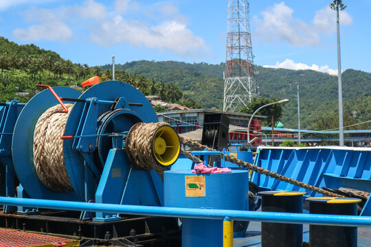 Mooring winch on a forward of a ferry with rope and chain in drum. Mechanical device equipment for ship mooring in port. Anchor winch mechanism in ship. windlass poop deck mooring rope