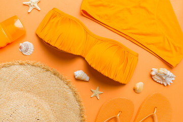 Woman swimwear and beach accessories flat lay top view on colored background Summer travel concept....
