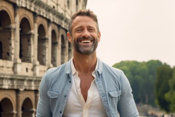 Portrait of handsome man in front of Colosseum in Rome, Italy