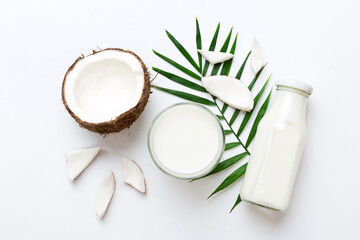 coconut products on white wooden table background. Dairy free milk substitute drink, Flat lay...