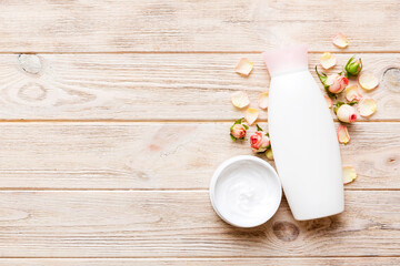 Fancy healthcare bottles for cream with rose flower. Natural oranic spa cosmetics concept. Mockup, template, Top view