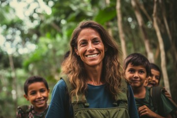 Portrait of smiling mother with kids in the jungle. Selective focus.