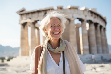 Portrait of happy senior woman standing at Acropolis in Athens, Greece