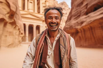 Fototapeten Medium shot portrait photography of a cheerful man in his 40s that is smiling with friends at the Petra in Maan Governorate Jordan . Generative AI © Leon Waltz