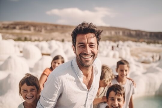 Happy father with his children on the background of the famous white sand castle.