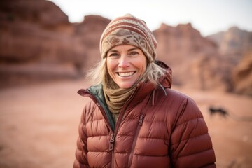 Fototapeta na wymiar Lifestyle portrait photography of a grinning woman in her 50s that is wearing a warm parka at the Petra in Maan Jordan . Generative AI