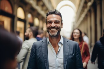 Portrait of a smiling mature businessman standing in the city street.