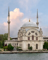 Fototapeta na wymiar View from Bosphorus strait overlooking Baroque style Dolmabahce Mosque, suited at the waterside of Kabatas, in Beyoglu district, Istanbul, Turkey