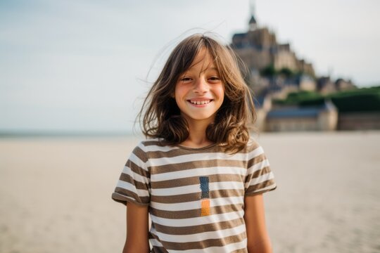 Portrait of a cute little girl on the beach in France.