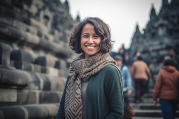 Fototapeta premium Young beautiful Asian tourist woman in the Prambanan temple, Java, Indonesia