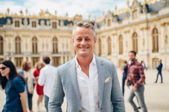 Handsome young man in front of the Versailles Palace