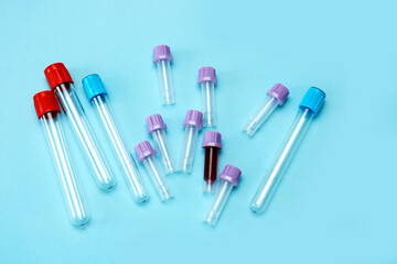 a test tube filled with blood among many empty test tubes on a blue background