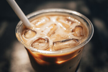 Ice cold refreshing iced caramel macchiato. Glistening ice cubes und delicious coffee.