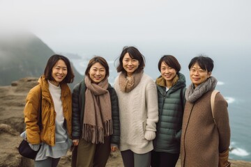 Group of asian women standing on top of a mountain in the fog