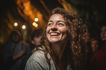 Portrait of a smiling young woman in a pub or club.