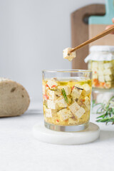 Marinated feta cheese cube in chopsticks, Cheese cubes marinated in olive oil, feta cheese with rosemary with dried pepper and tomatoes