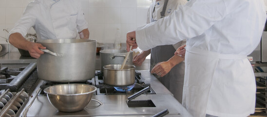 Cooking school chef team helping each other to finish the good food