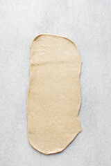 Rolling out dough for making swedish cinnamon buns, process of making Swedish cinnamon buns or homemade Kanelbullar