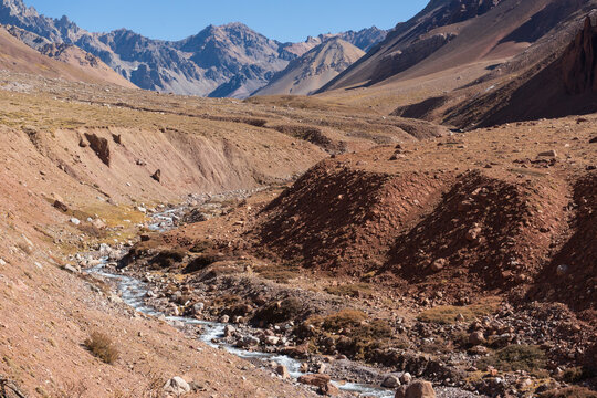 Beautiful valley with river surrounded by the andes mountains in Mendoza, Argentina.