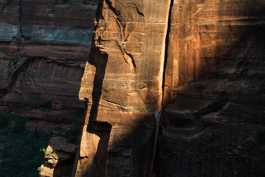 Sheer sandstone walls split be cracks in Zion National Park, Utah