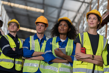 Group of warehouse workers standing with crossed arms in storage warehouse. Complete finish job. Successful of work concept