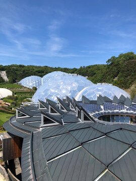 Eco-park of the Eden Project view of the biomes and the roof of the Core building, Cornwall, England, UK. The rooftop of the CORE, Information Centre for the Eden Project