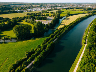 Summer aerial drone view landscape navigable river with bridges, agricultural fields and forests...