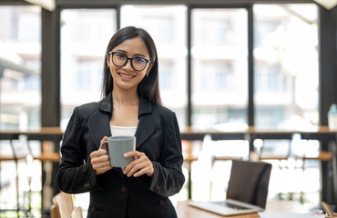 business woman smiling confidently on relax time with coffee at office.