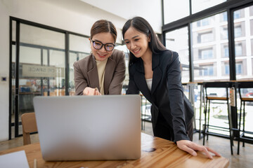 Business colleagues working on laptop. Working together on a project plan.