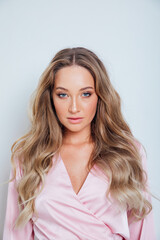 portrait of a beautiful blonde woman in a pink dress