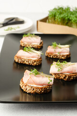 Healthy snacks or starter, appetizer with organic microgreens growing at home for healthy eating or for restaurant. Close up