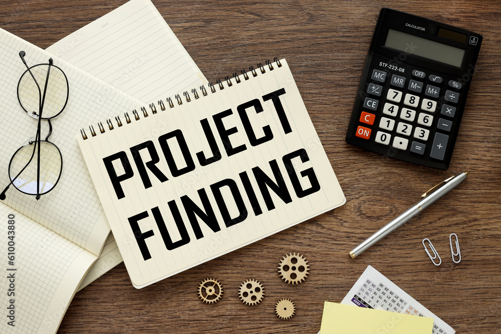 Poster projects and funding. open notepad with text on notebook on work table