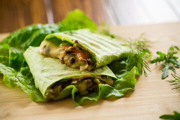 green hot vegetarian pita bread with mushrooms and different vegetables, with lettuce leaves .