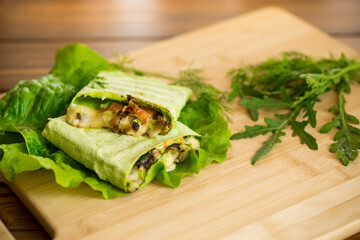 green hot vegetarian pita bread with mushrooms and different vegetables, with lettuce leaves .