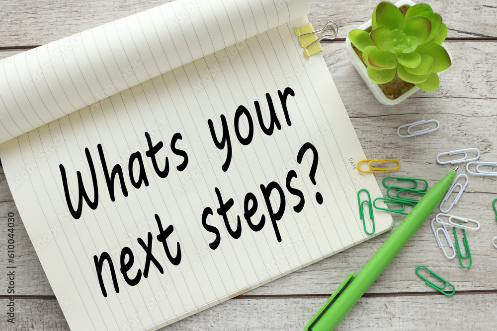 Poster what's your next step? large notepad with text near a plant in pots and glasses