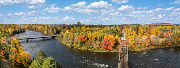 Autumn colors on the river at Moosehead Lake, Maine - train trestle © Craig Zerbe