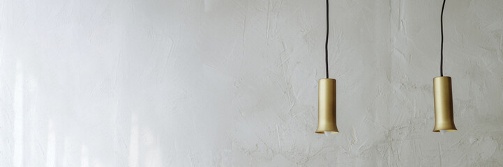 Two light bulbs in vintage style on a white cement wall background. The lights are turned off. Banner for website header design with copy space.