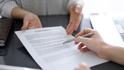 Businesswoman lawyer pointing into contract special points admitting something for colleague or client at meeting. Business people teamwork and partnership.