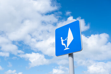 Sailboard sign over blue sky