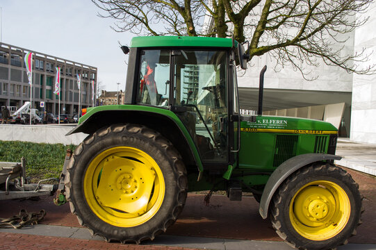 Arnhem, Netherlands - February 21, 2020: A green John Deere farmer tractor in the center of Arnhem