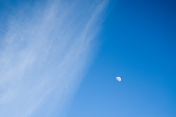 A little bit cloudy sky and moon. 