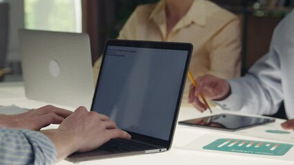 Making notes on laptop. Business people meeting, conference, working on news project, developing strategy for product launching. Concept of business, office, teamwork, brainstorming, meeting