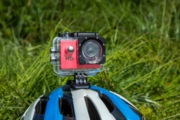 Action camera in a protective box on a bicycle helmet.