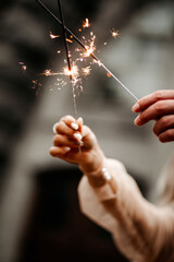 two sparklers are burning. Sparklers in the hands of the bride and groom