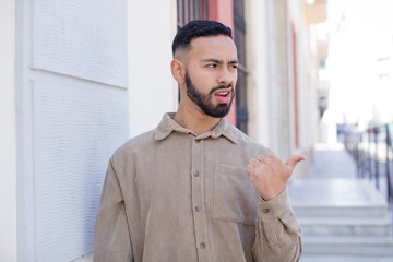 Obraz premium young handsome man worried, feeling scared, frustrated and stressed