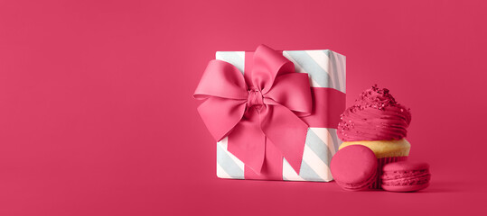 Beautiful gift box and sweets on magenta background with space for text