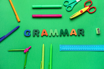 Word GRAMMAR with school stationery on green background
